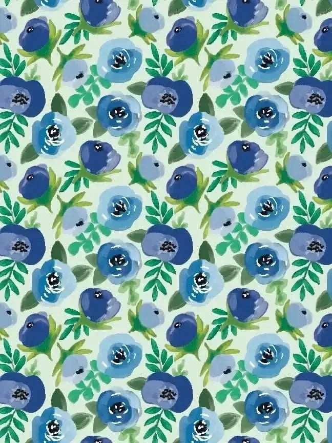 Blue buttercups floral fabric with green leaves on a light green background.