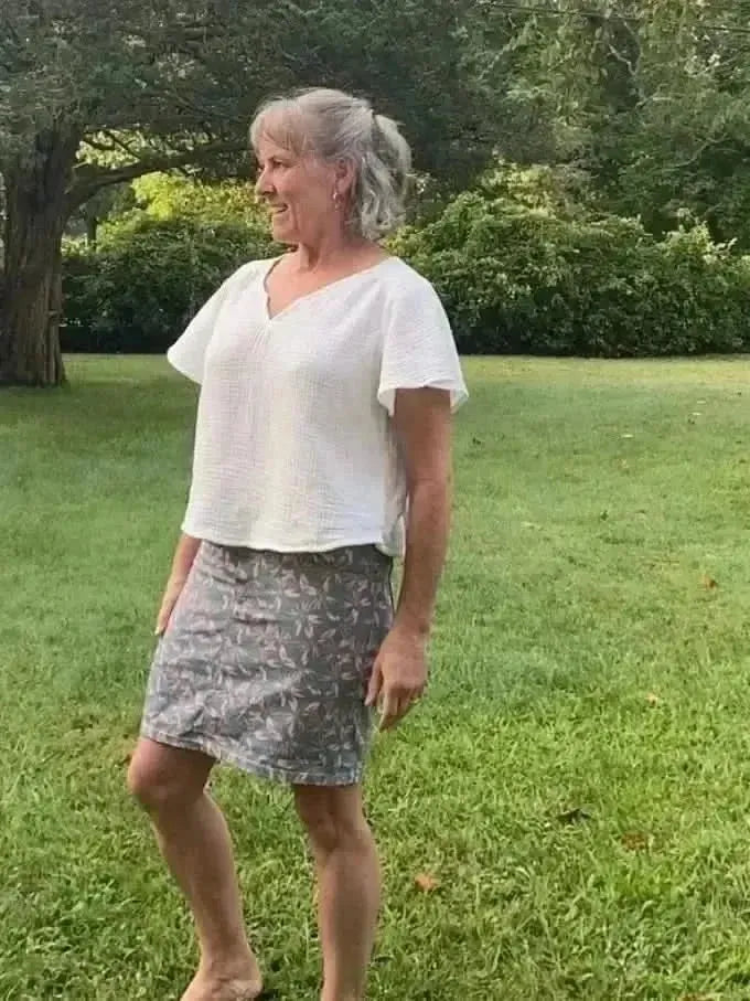 Blush hollow floral print fabric with gray and pink tones.