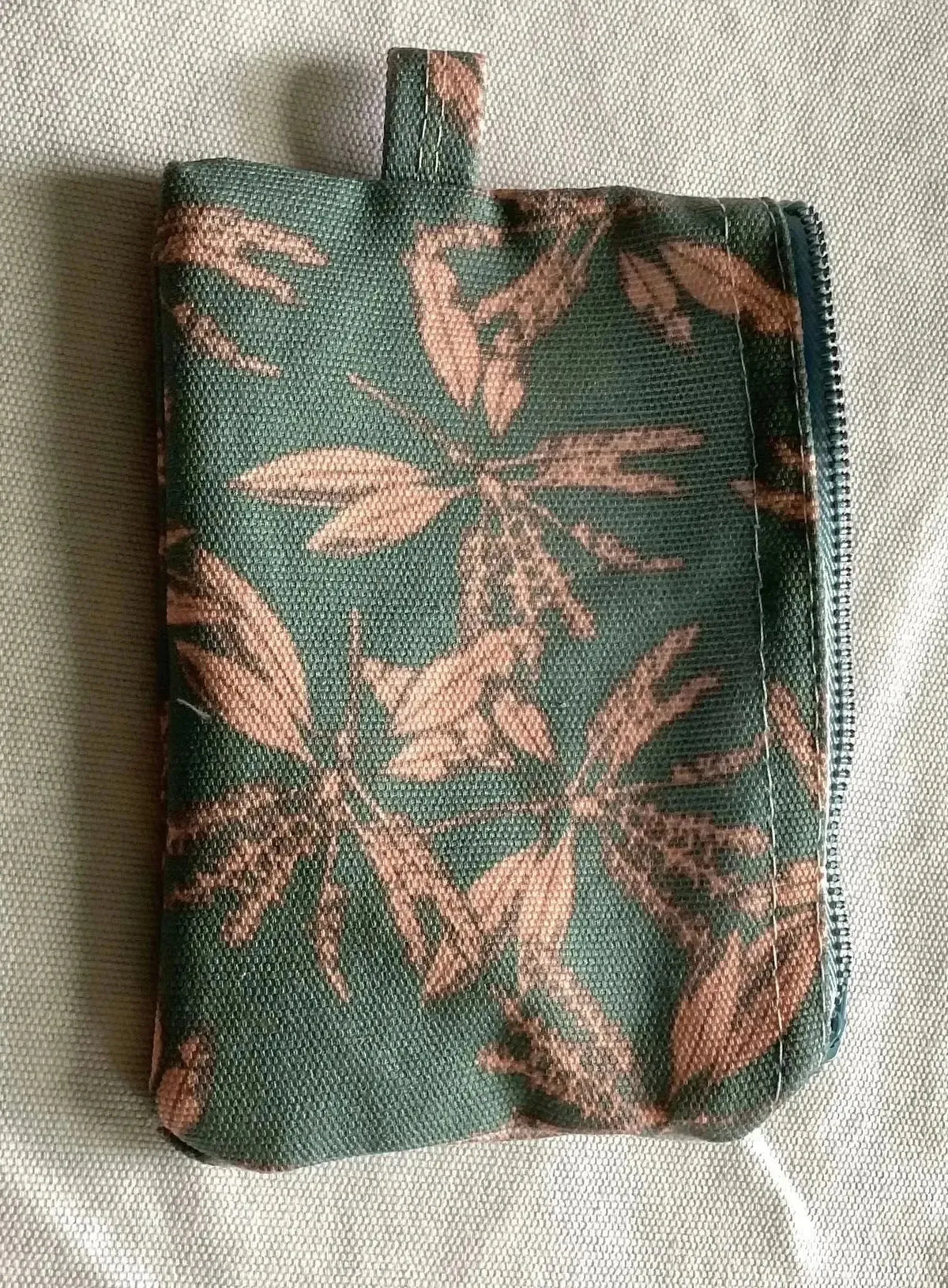 Blush hollow floral print fabric with green leaves on blush background.