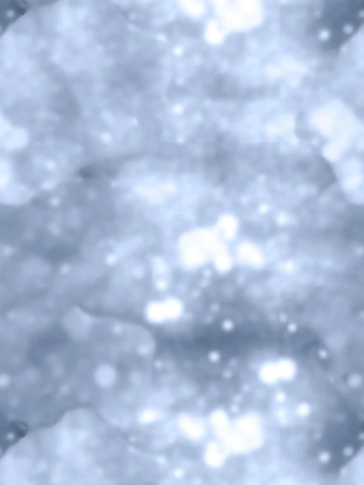Blurred blue glitter fabric with soft white highlights.