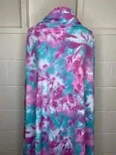 Mermaid tie dye fabric with aqua and pink print, shown draped on a mannequin.
