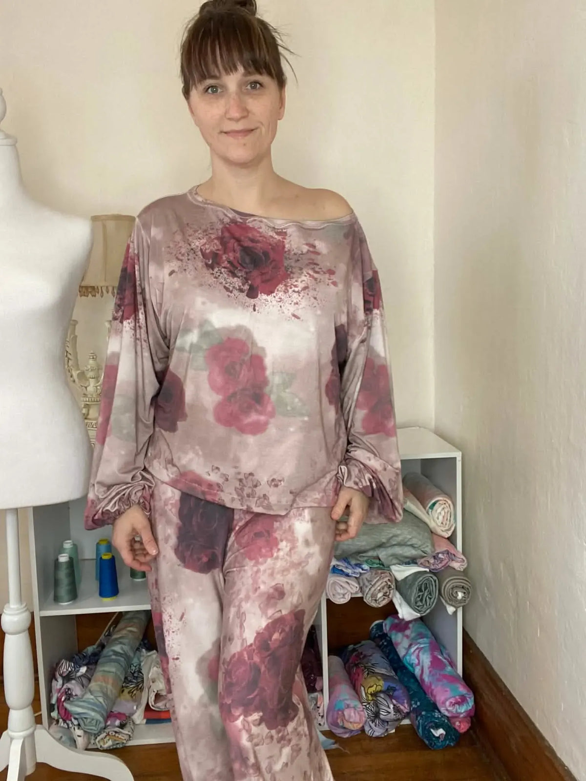 A woman models a two-piece outfit with a shattered rose pattern.