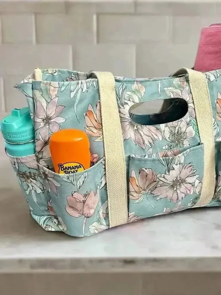 Blue floral fabric swatch with misty lane pattern on a neutral background.