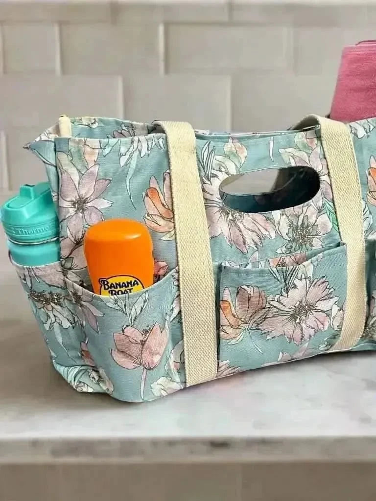 Blue floral fabric swatch with misty lane pattern on a neutral background.