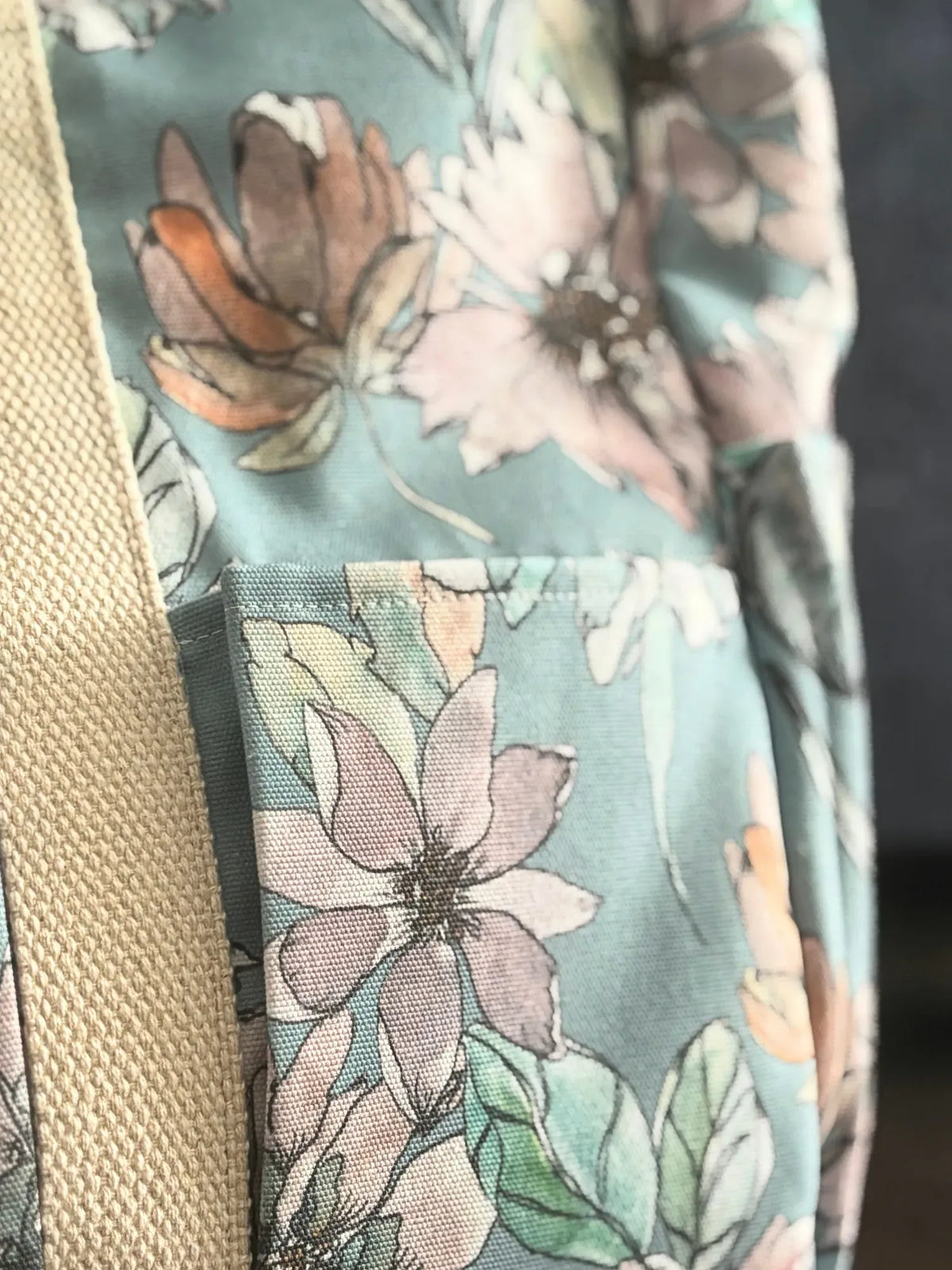 Close-up of a floral fabric with a beige strap.