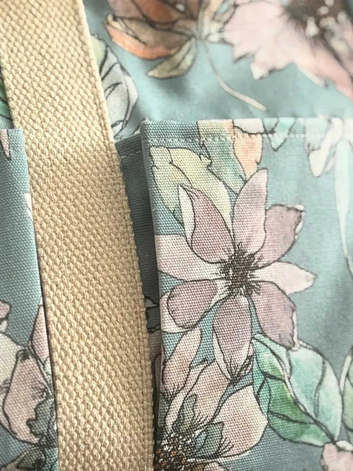 Blue floral fabric with watercolor-style flowers on a misty background.