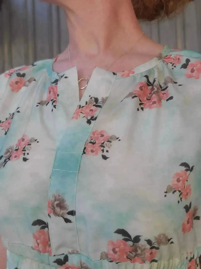 Light blue fabric with floating pink peony floral print.