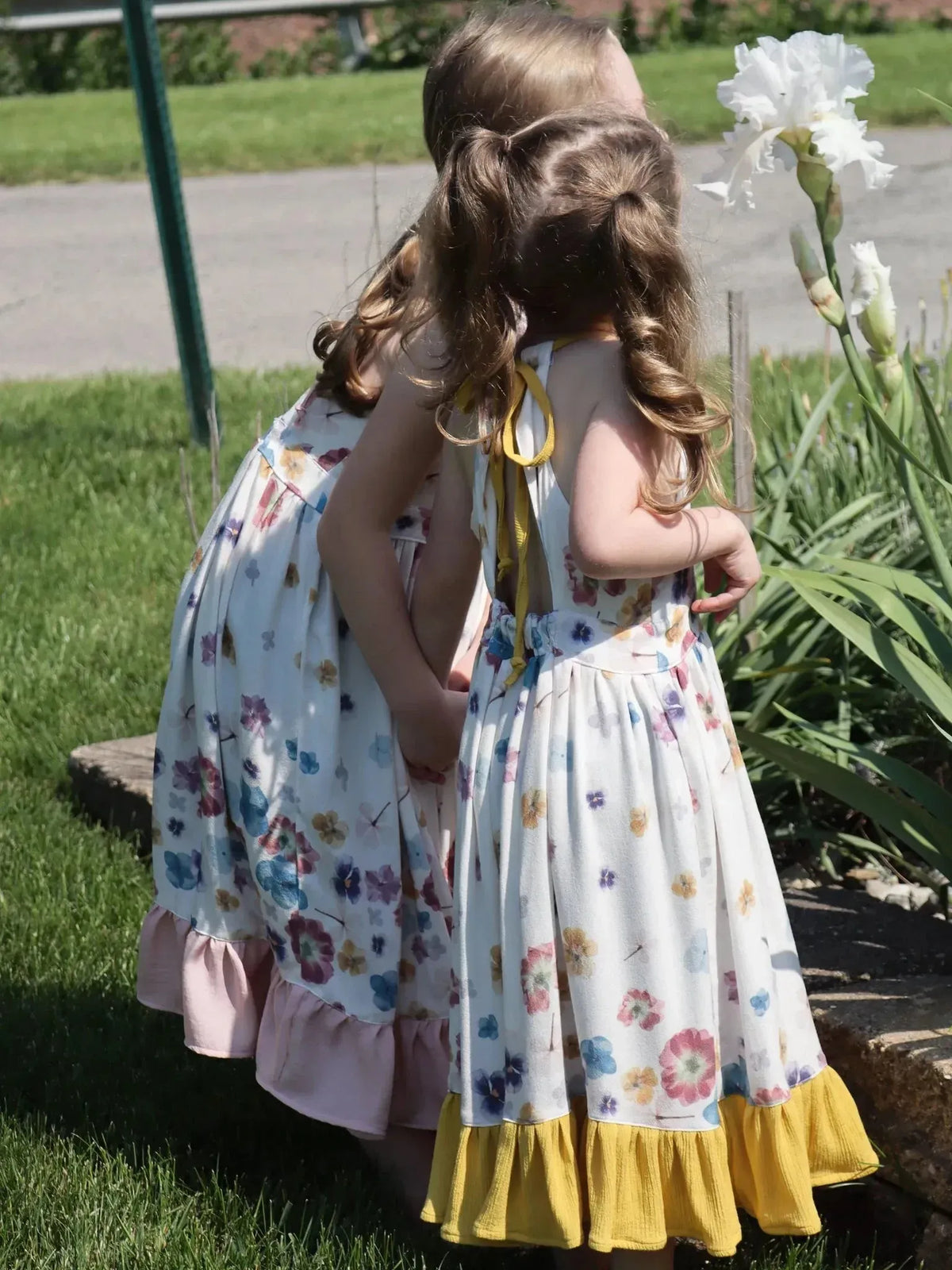 Hand-pressed floral fabric with pastel blooms print on white background.