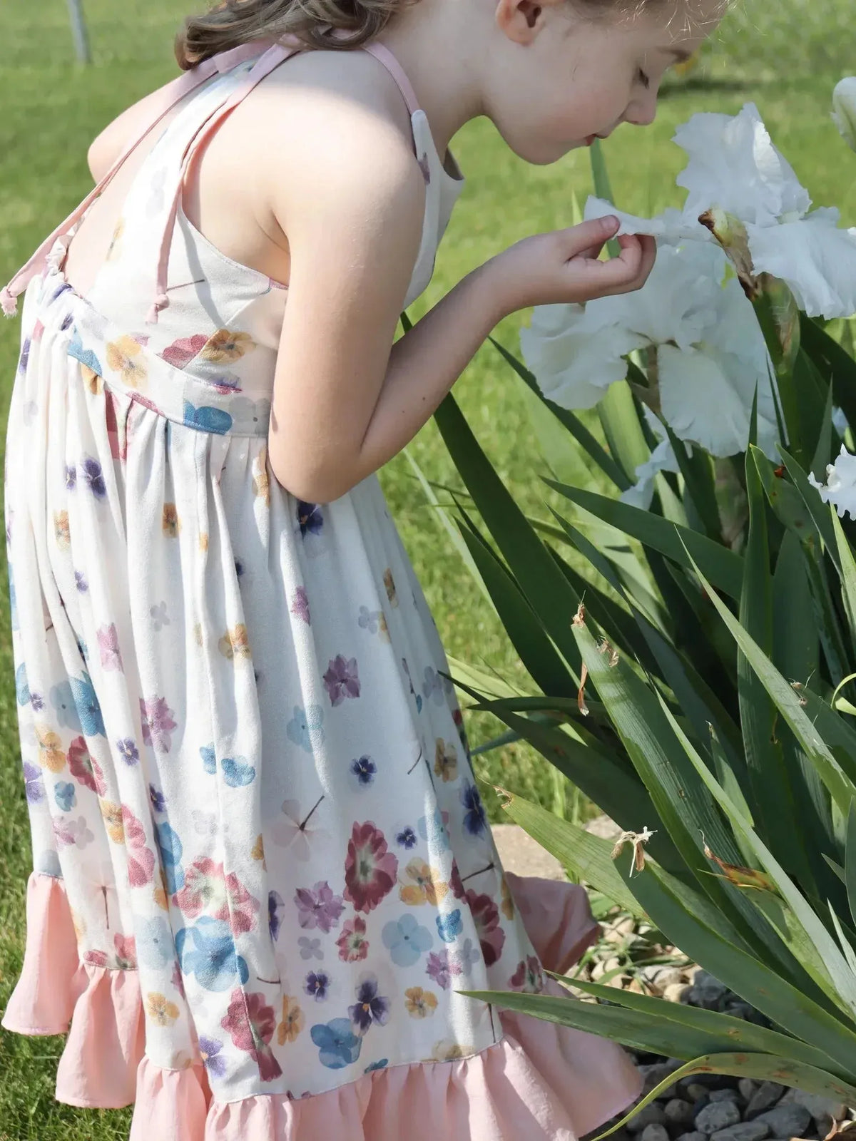Pastel floral print fabric with hand-pressed blooms in soft colors.
