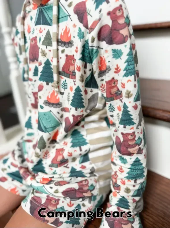 A child wears a "Camping Bears" hoodie and shorts set with a nature-themed print.