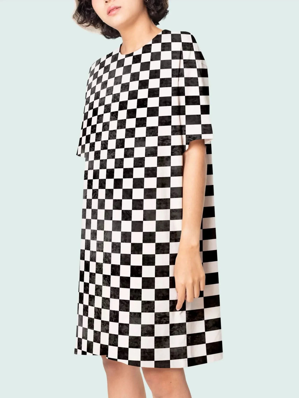 A person wears a black and white checkered dress.