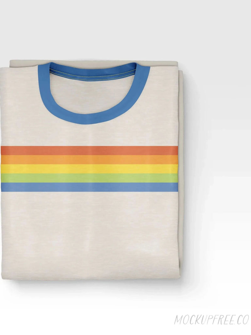 Folded cream t-shirt with a blue collar and horizontal rainbow stripes.