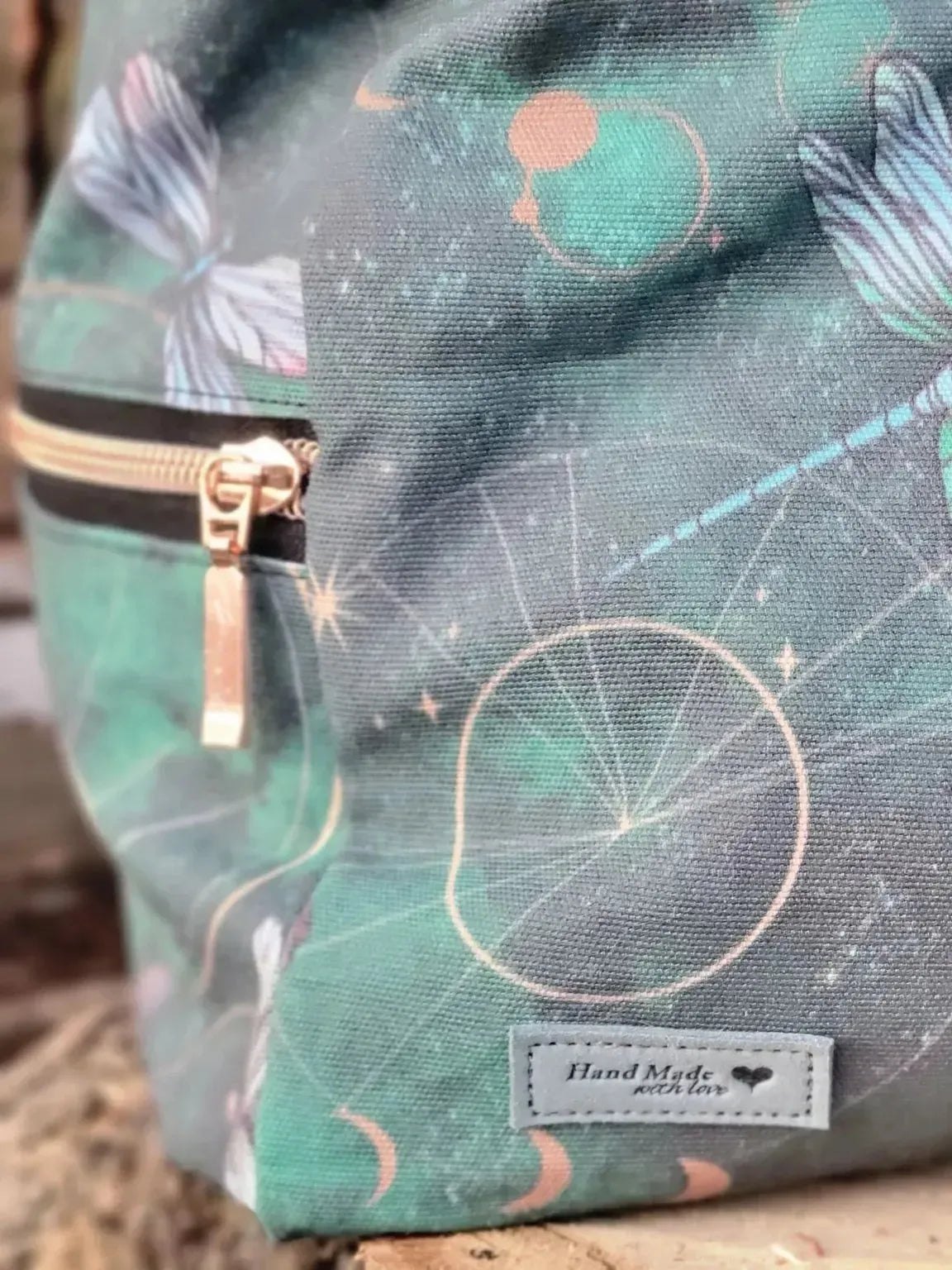 Celestial dragonflies print on green fabric with cosmic motifs.