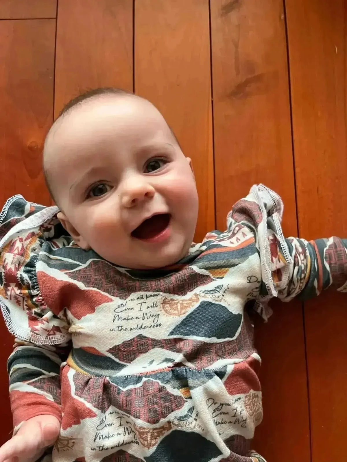 Baby onesie made from WayMaker Fabrics' Make a Way faith-based print.