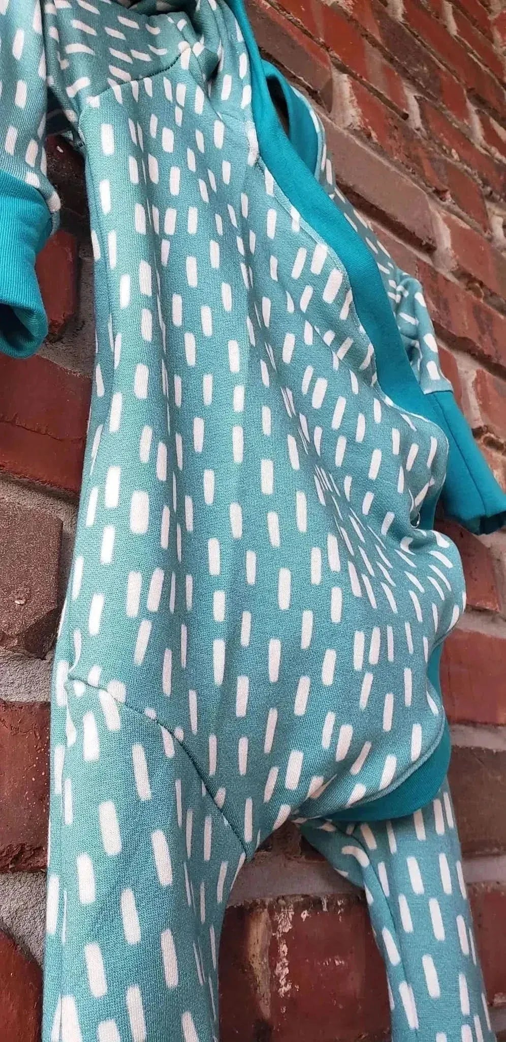 Blue dash pattern print fabric from WayMaker Fabrics, featuring white dashes on a teal background.