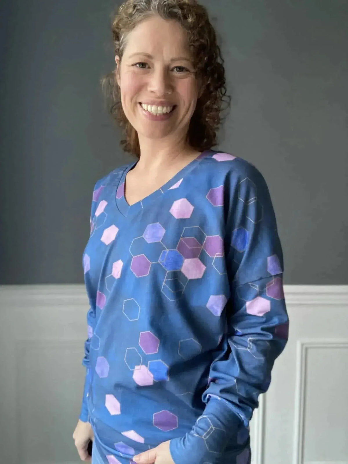 Blue geometric hexagon print fabric with purple accents on a cotton base.