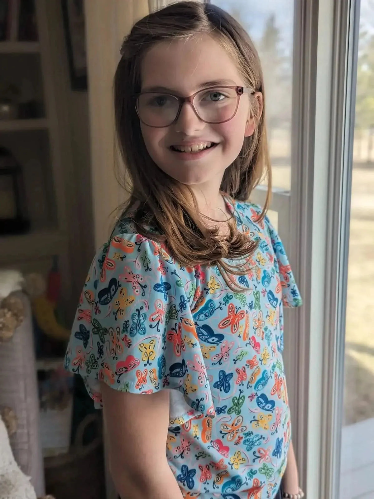 Light blue fabric with vibrant painted butterfly print.