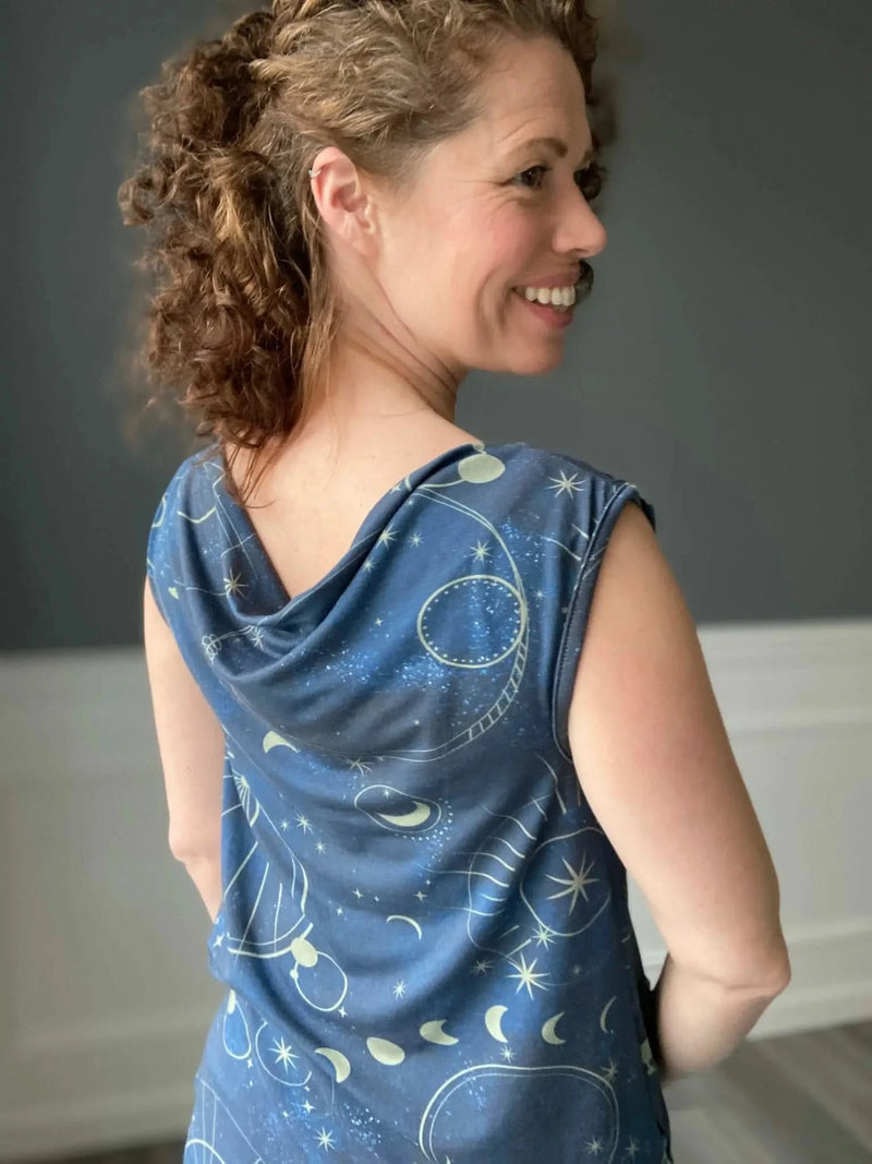 A woman models a blue top with a celestial sky pattern.