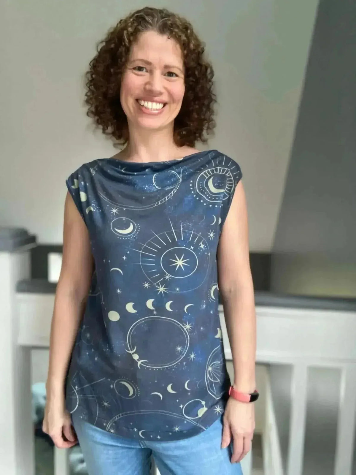 Navy fabric with cosmic galaxy print featuring stars, moons, and celestial motifs.