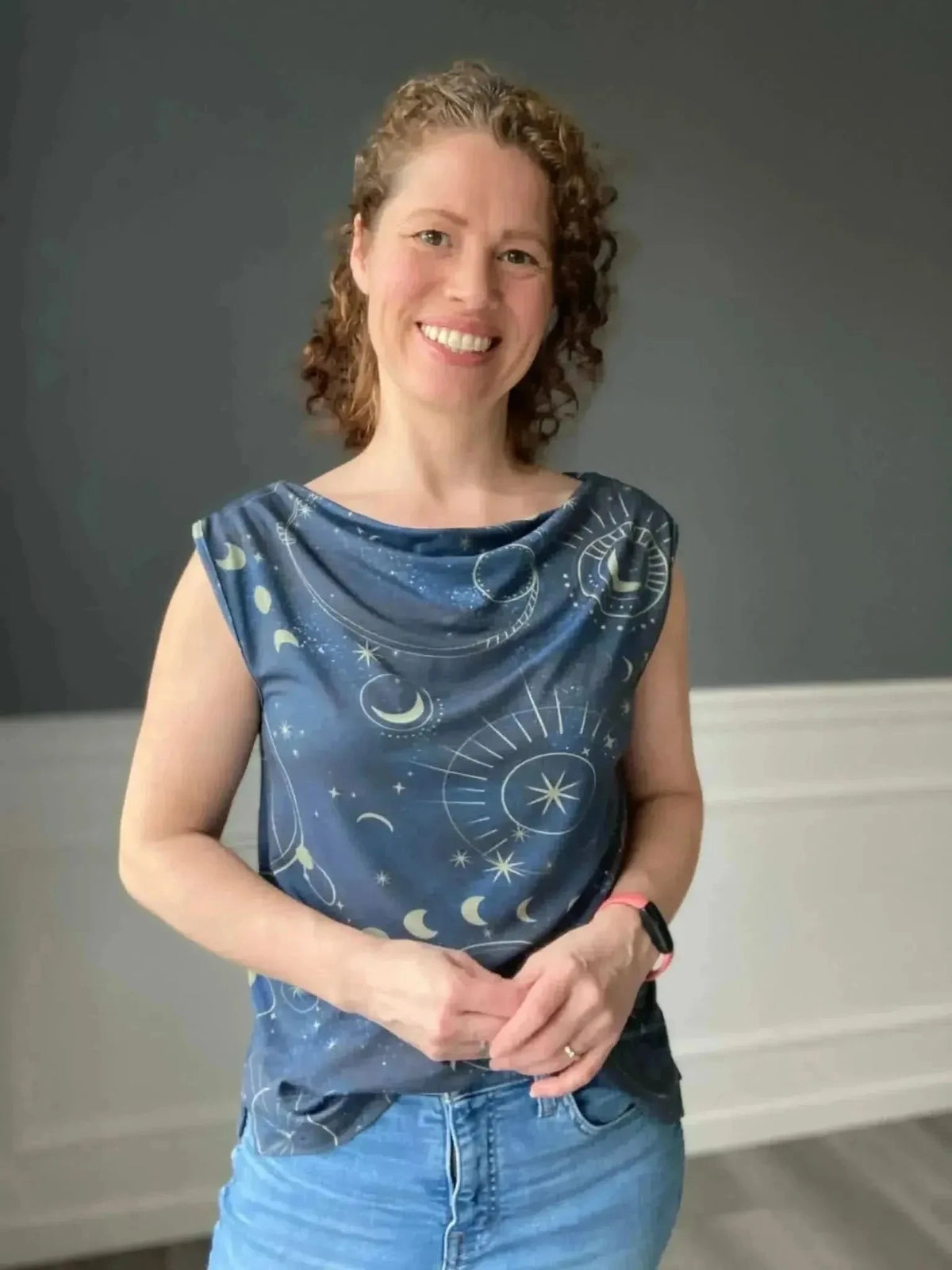 Navy fabric with celestial print of moons and suns on a cosmic galaxy pattern.