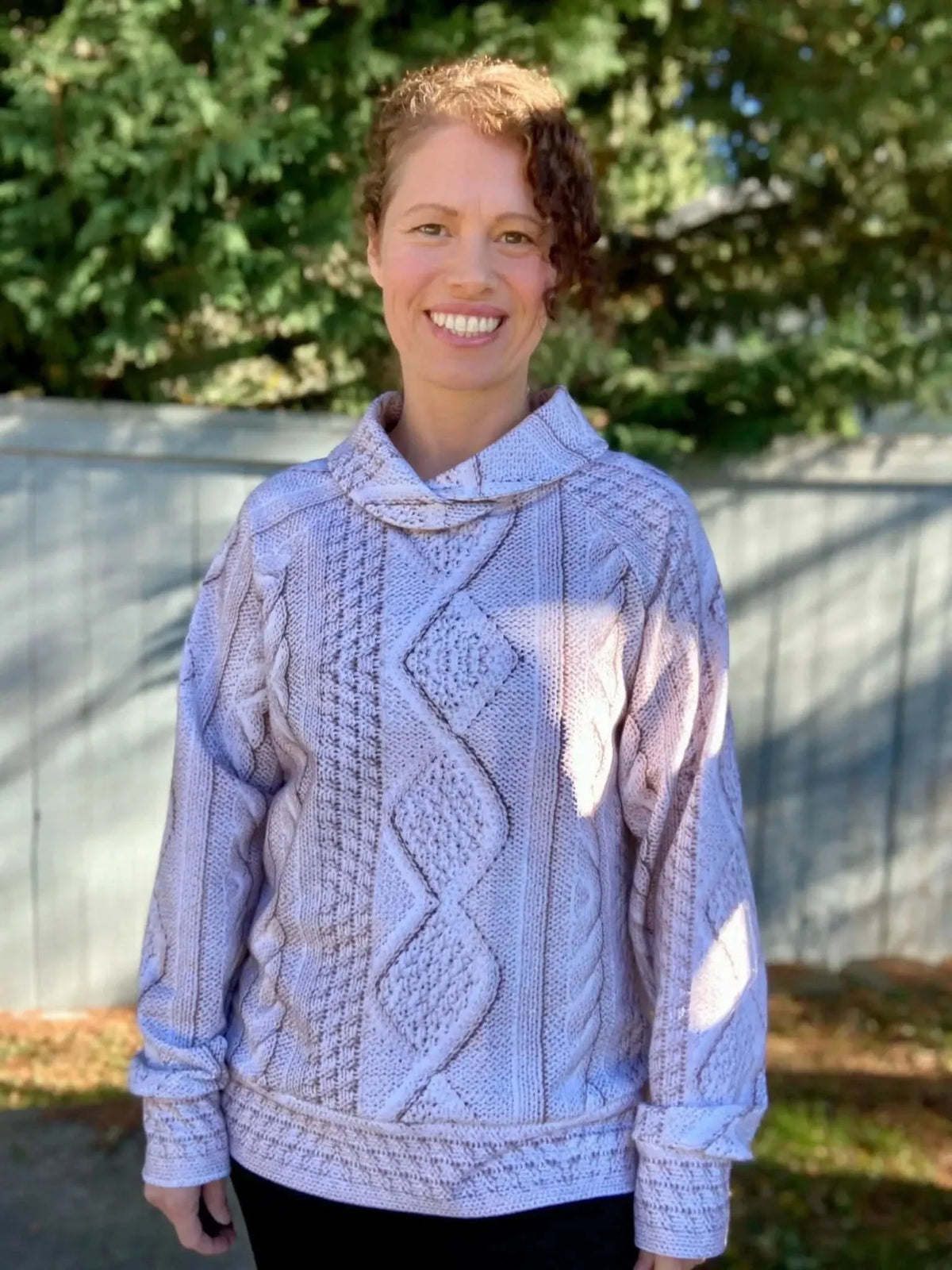 Cream cable knit fabric in light beige with textured knit pattern.