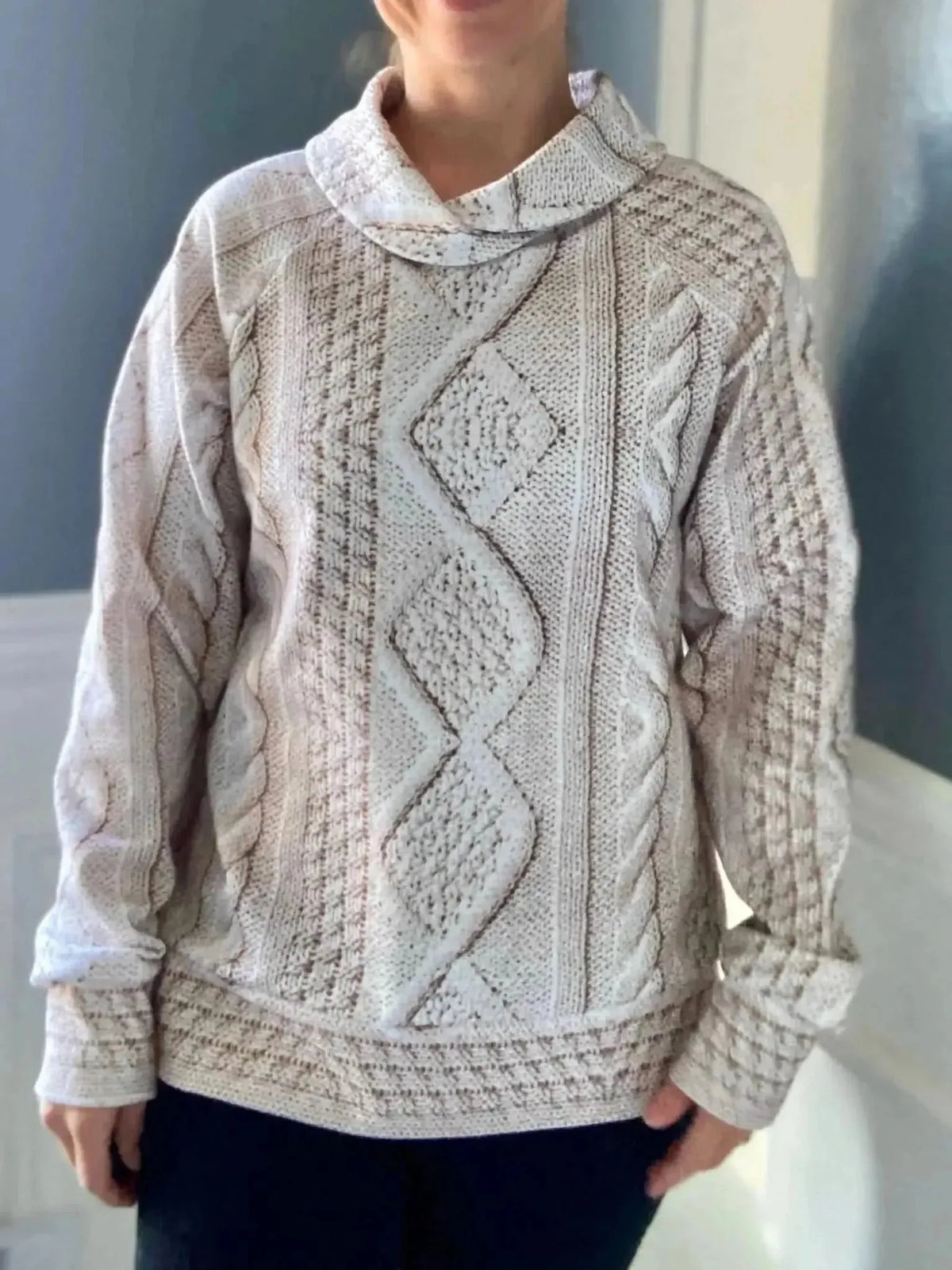 Cream cable knit fabric in off-white with textured diamond patterns.