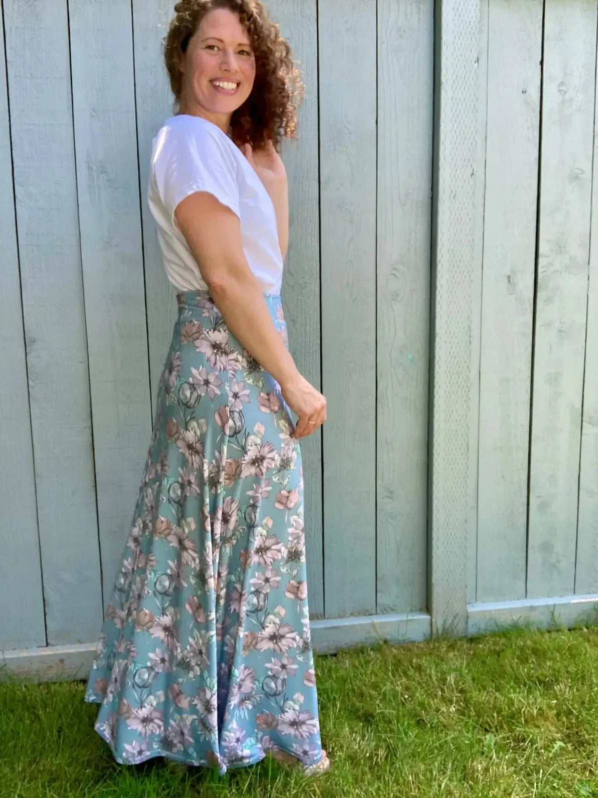 Blue floral fabric with misty lane pattern, shown as a side-view maxi skirt on a model.