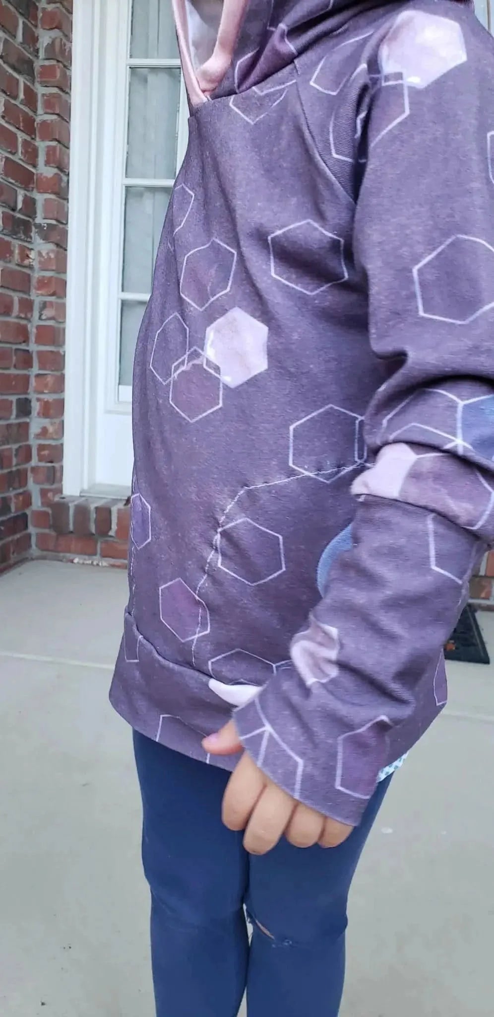 Burgundy geometric hexagon print fabric with a subtle pink hue.