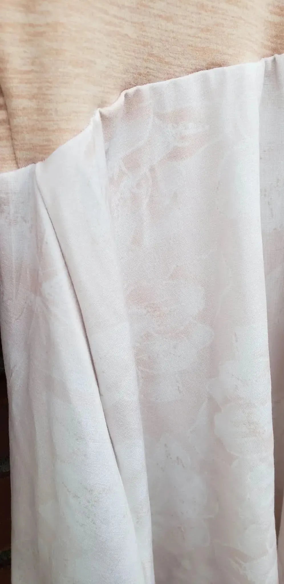 Pink fabric with a subtle floral pattern.