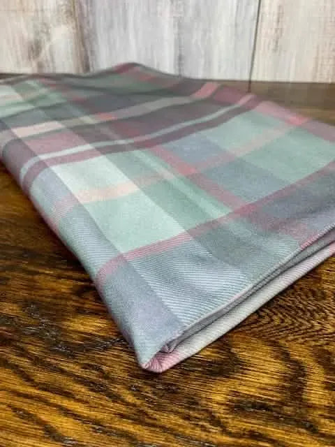 Dark Christmas Plaid fabric folded on a wooden surface.