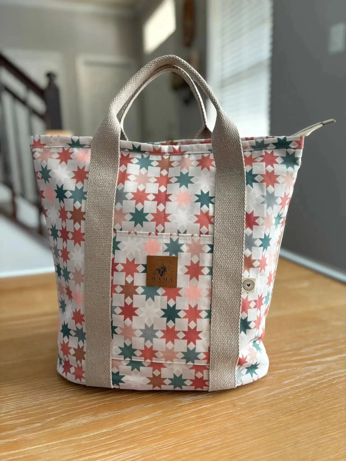 Pink and white geometric star print fabric with a subtle brand logo.