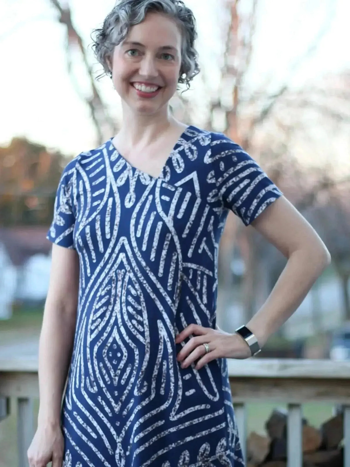 Blue geometric Art Deco print fabric with white zigzag patterns on a navy background.