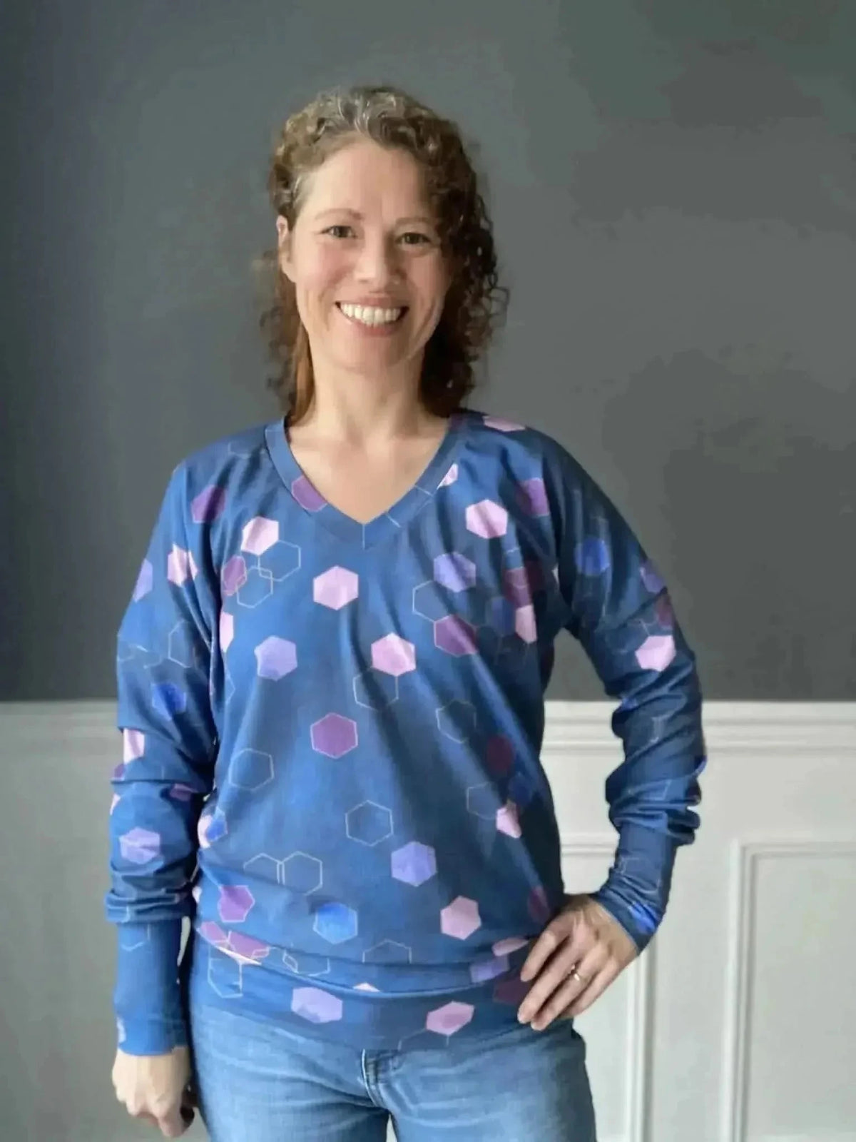 Blue geometric hexagon print fabric with purple accents on a navy base.