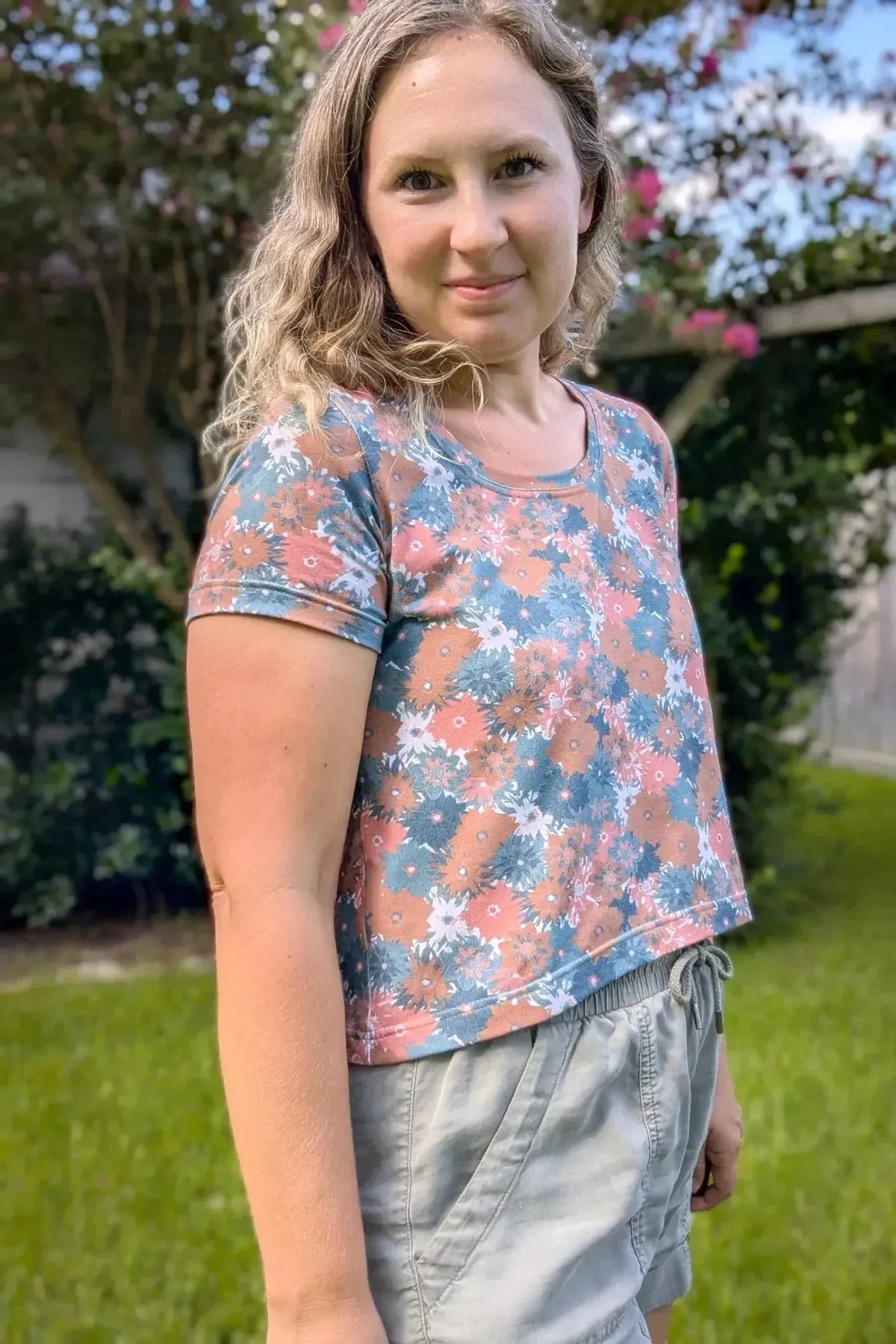 Floral print fabric in orange and blue tones on a white background.