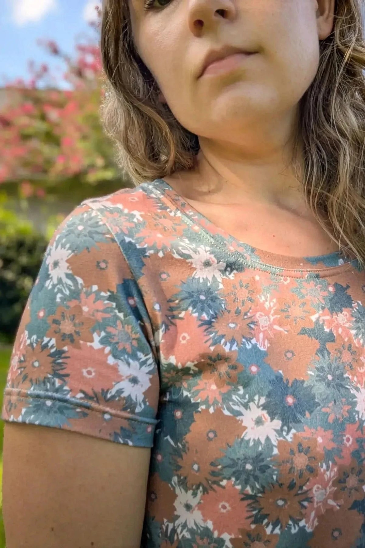 Close-up of a woman modeling a short-sleeved top in Evening Grace floral print fabric.