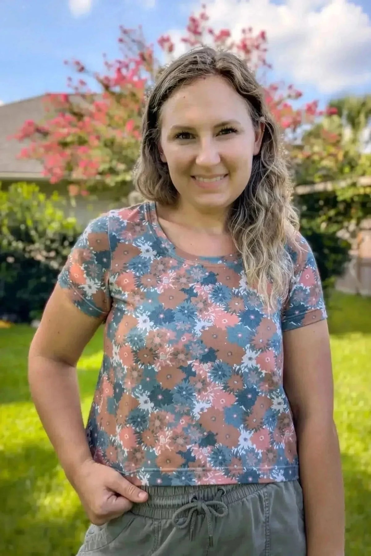 Woman modeling a short-sleeve crewneck top in Evening Grace floral print fabric.