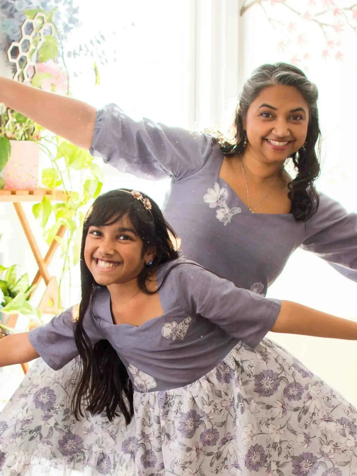 Faded purple floral linen fabric with subtle embroidery and soft drape.