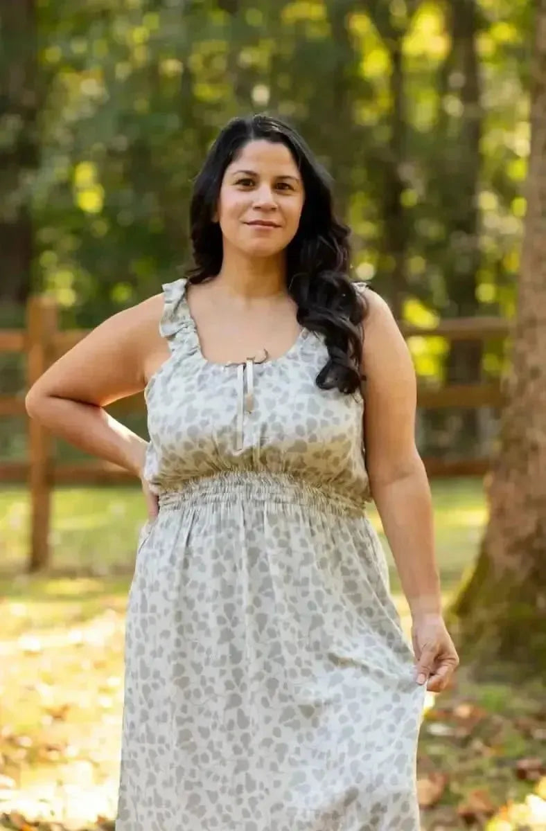 Green leaf print fabric with nature-inspired pattern on light background.
