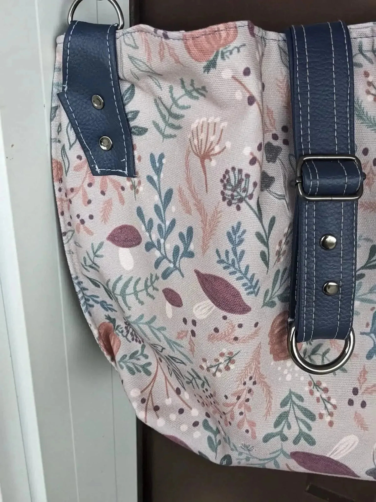 Tan botanical fabric with forest foliage print of leaves, mushrooms, and berries.