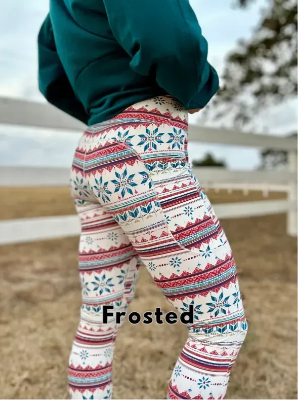 A person wears white leggings with a red and blue snowflake pattern.