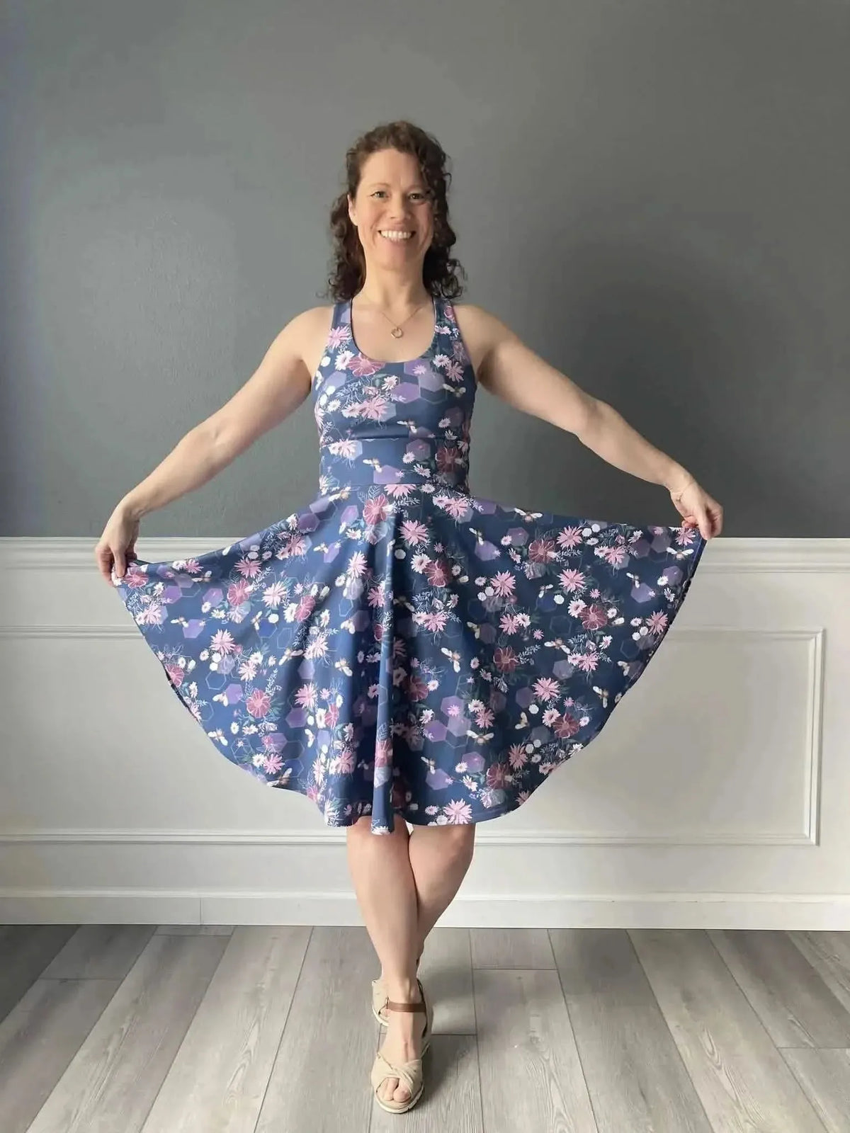 Purple fabric with garden bees print, shown as a flared sleeveless dress on a model.