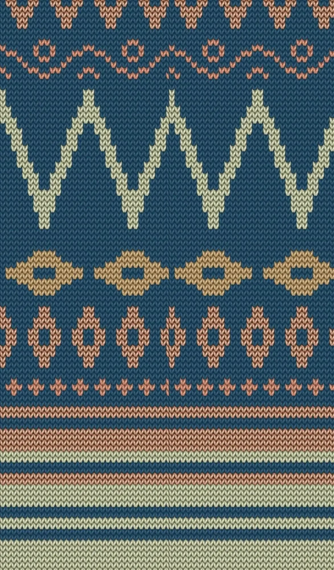 A blue knit fabric with geometric patterns in cream, brown, and peach.