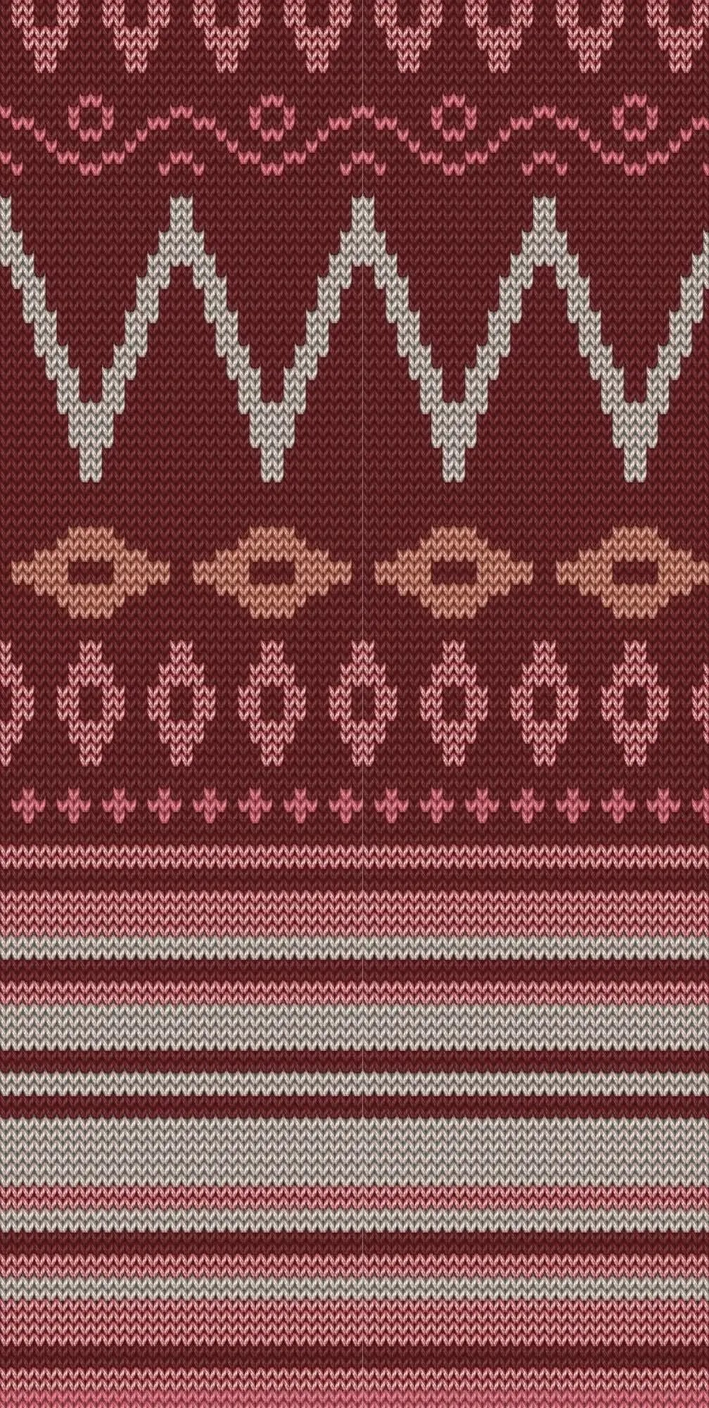 Knitted fabric with red, pink, and beige geometric patterns.
