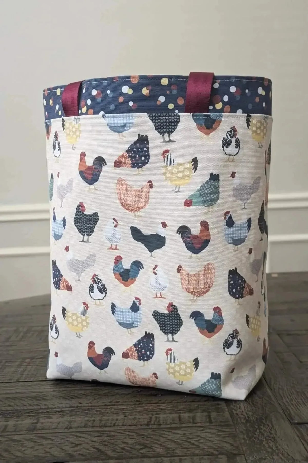 Patchwork print fabric featuring colorful chickens on a light background.