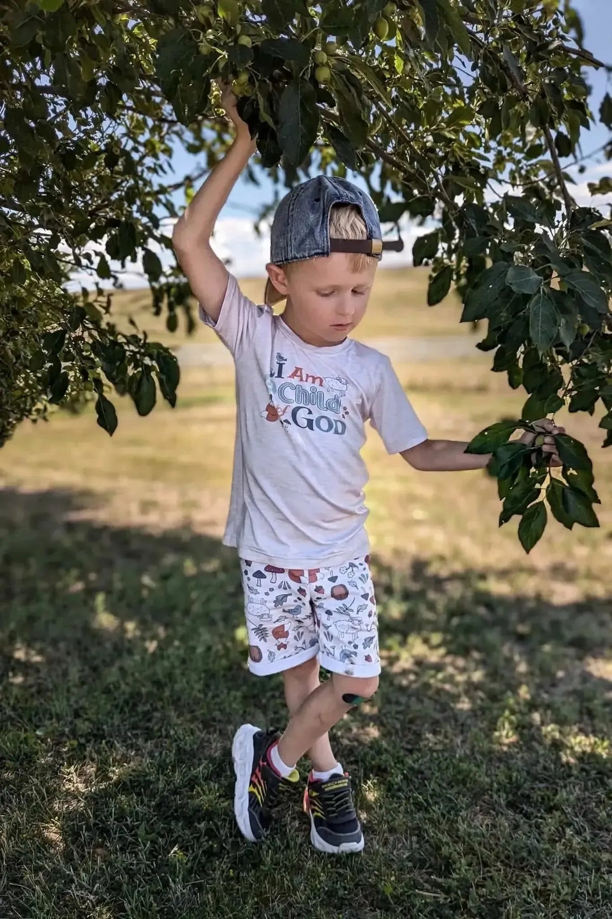 Sandy print fabric featuring woodland creatures in soft beige tones.