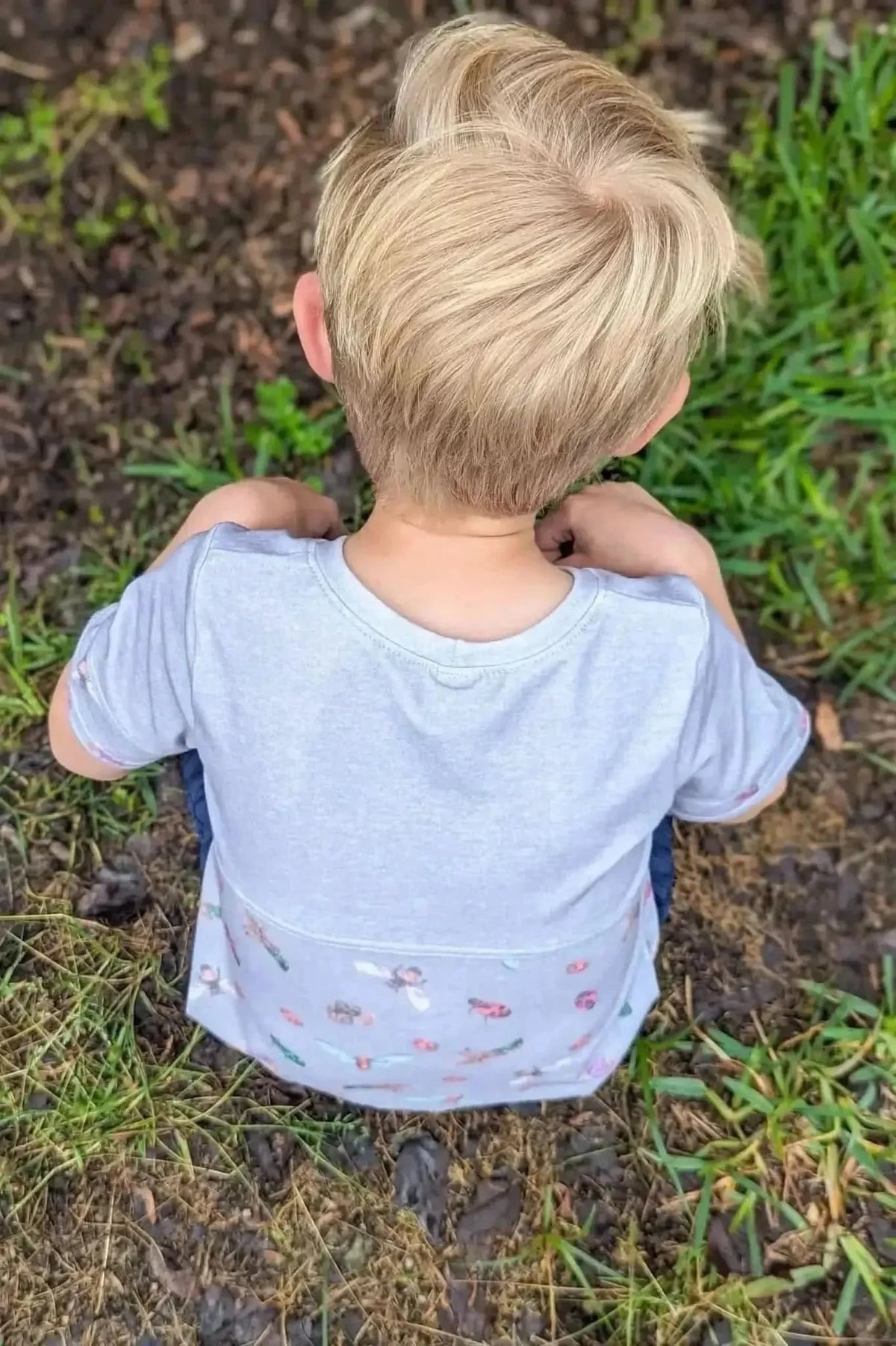 Light grey quilting cotton fabric with a subtle bugs print pattern.