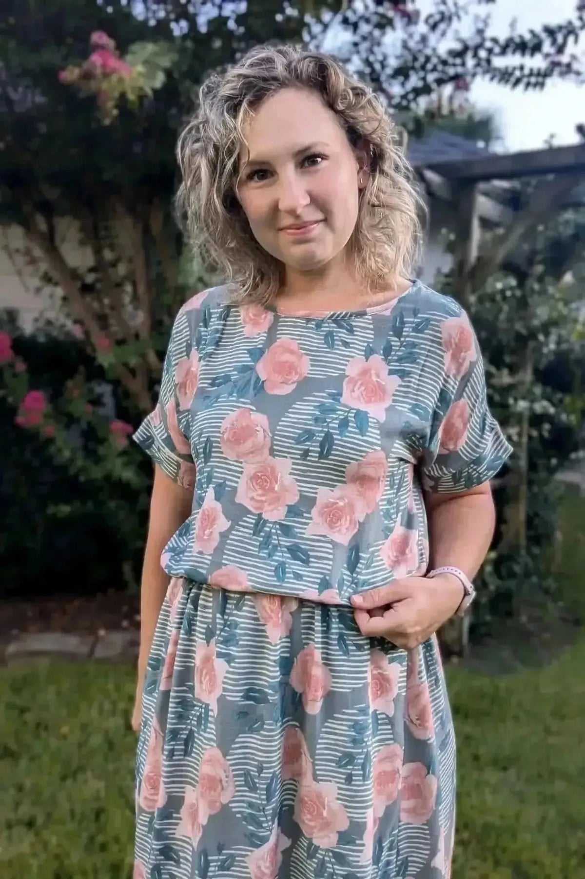 Wild Rose floral print fabric with pink roses on a green background.