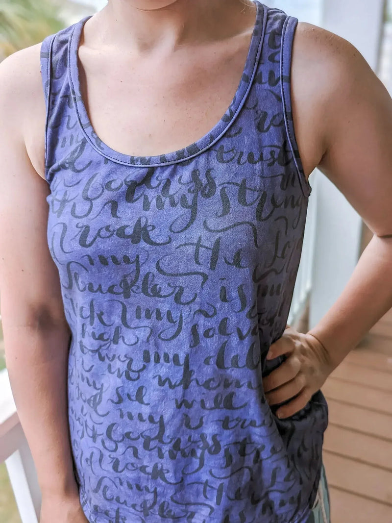 Purple tank top with black script lettering.