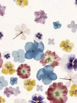 A white fabric with a pattern of colorful, pressed flowers scattered across it.