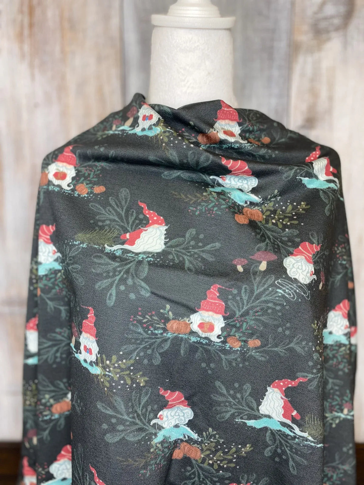 Gnome Toile in Green fabric draped over a mannequin.